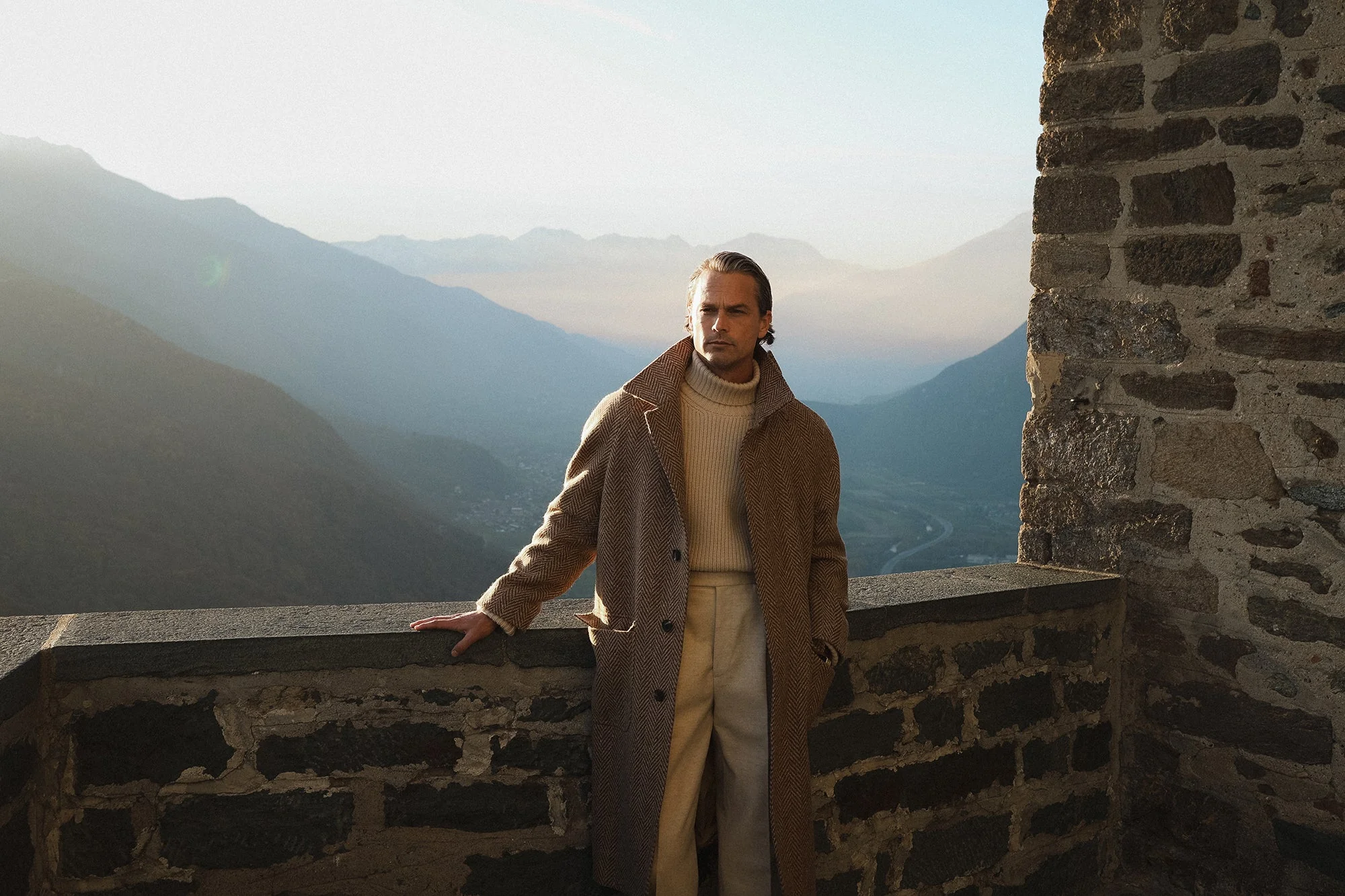 A photograph of a man wearing a Berg & Berg coat and jeans.