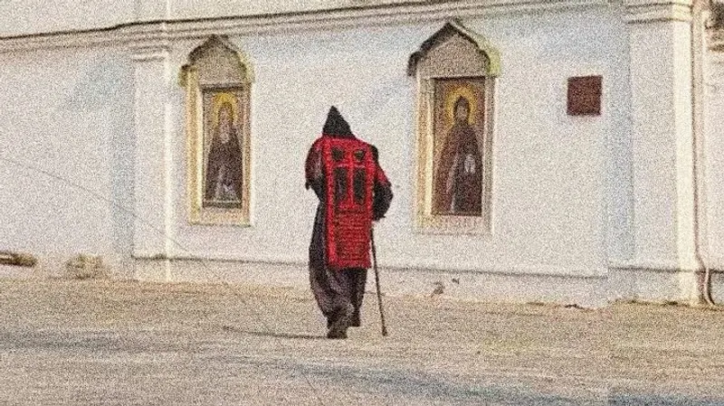 One of harmony's thumbnails. It shows an Orthodox Schemamonk walking next to a church.